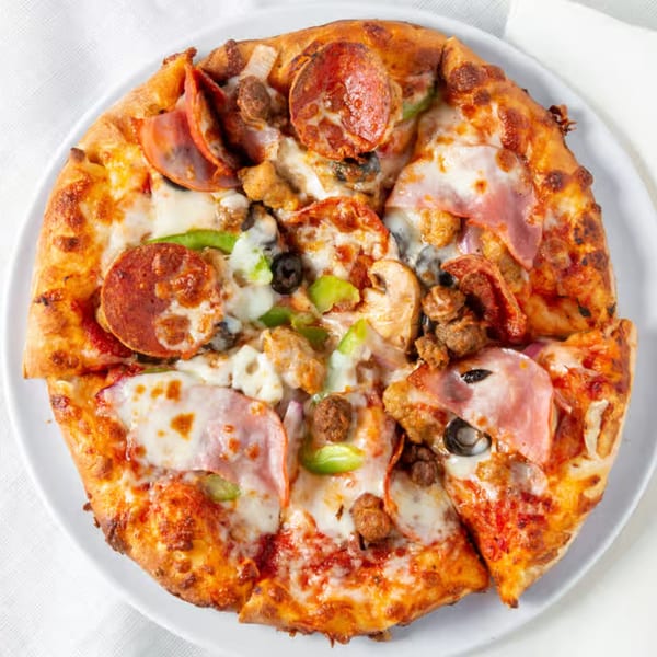 A Rock Creek Pizza with pepperoni, ham, sausage, mushrooms, green peppers, and black olives.