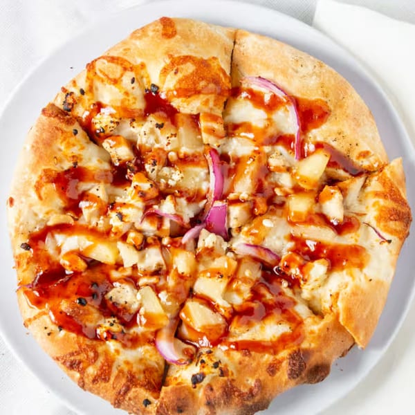 Rock Creek Pizza's BBQ chicken pizza, topped with chicken, red onion, pineapple, and BBQ sauce.